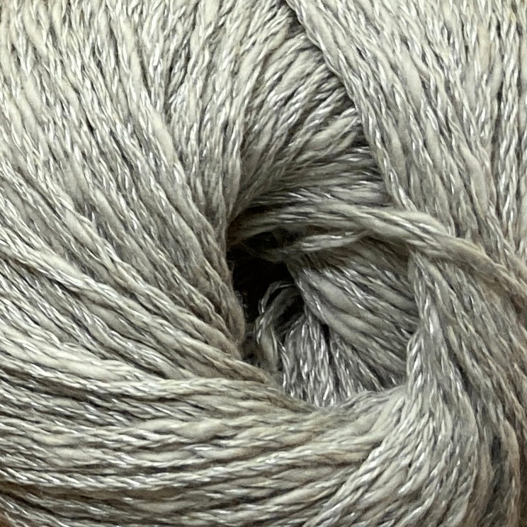Close up on a warm gray ball of Katia Liana yarn.