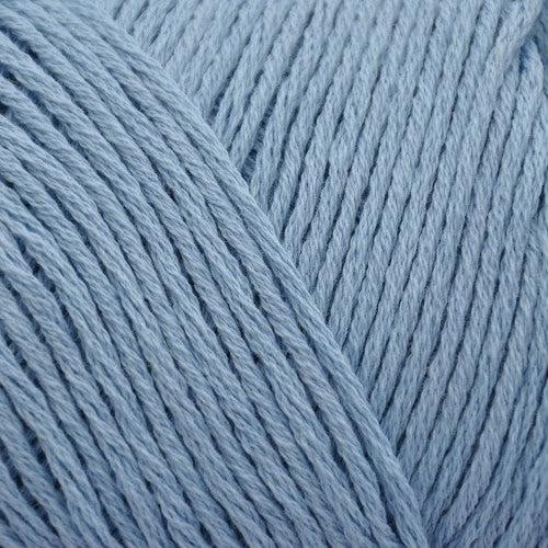 Close up on a light blue skein of Brown Sheep Cotton Fleece yarn.