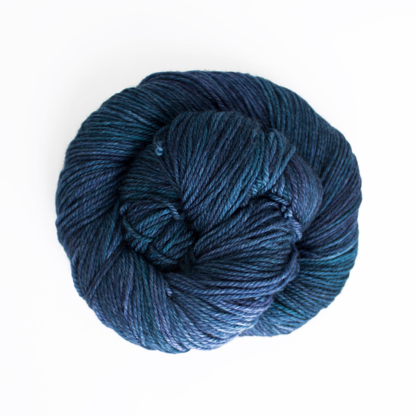 Skein of variegated blue and teal Malabrigo Finito yarn.