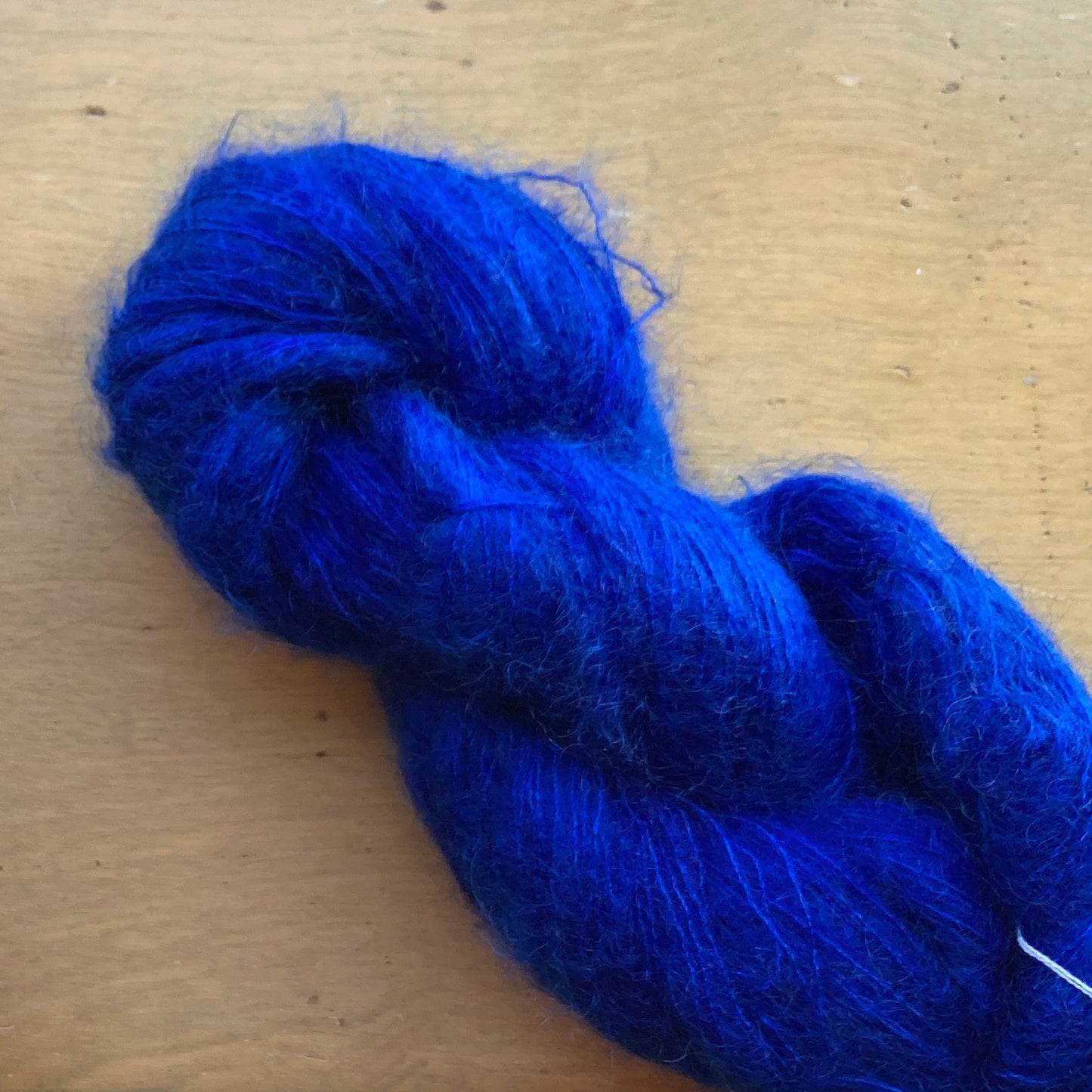 Cobalt blue skein of Fleece Artist / Hand Maiden Superkid Silk yarn, colorway Stellar’s Jay
