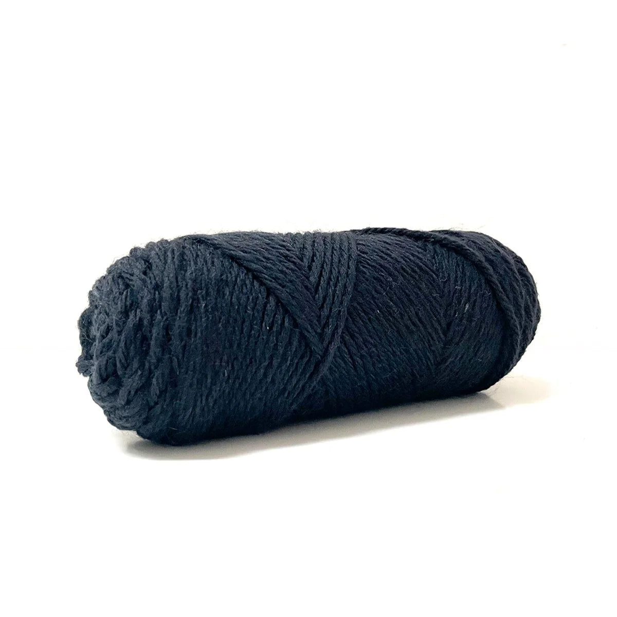 A skein of black Kelbourne Woolens Germantown Bulky yarn.