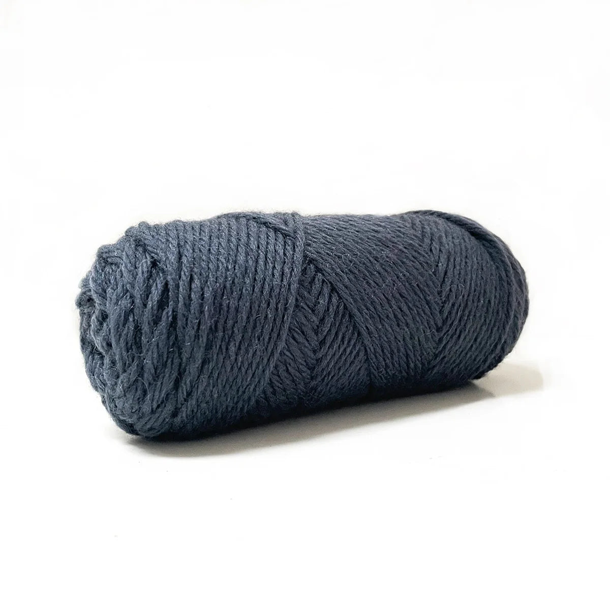A skein of dark gray Kelbourne Woolens Germantown Bulky yarn.