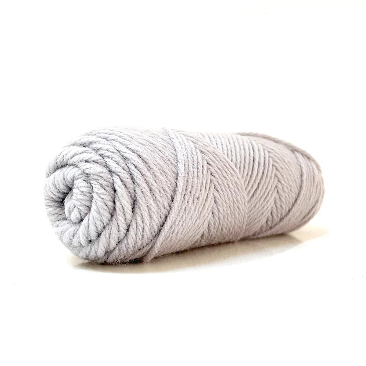 A skein of silver gray Kelbourne Woolens Germantown Bulky yarn.
