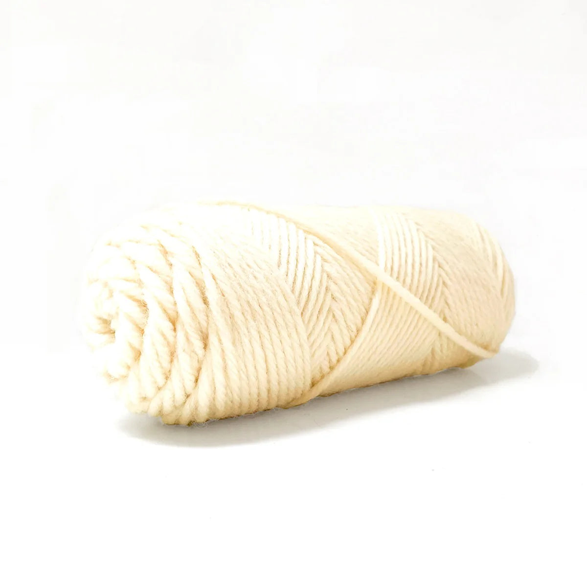A skein of natural white Kelbourne Woolens Germantown Bulky yarn.