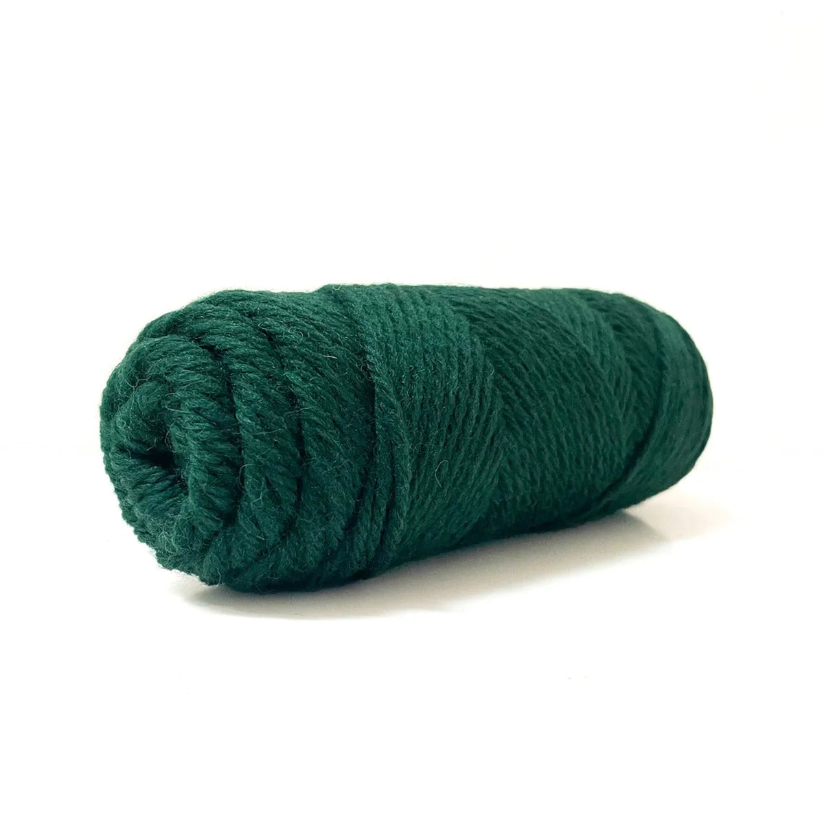 A skein of forest green Kelbourne Woolens Germantown Bulky yarn.