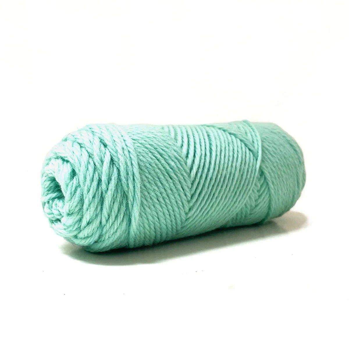 A skein of mint green Kelbourne Woolens Germantown Bulky yarn.