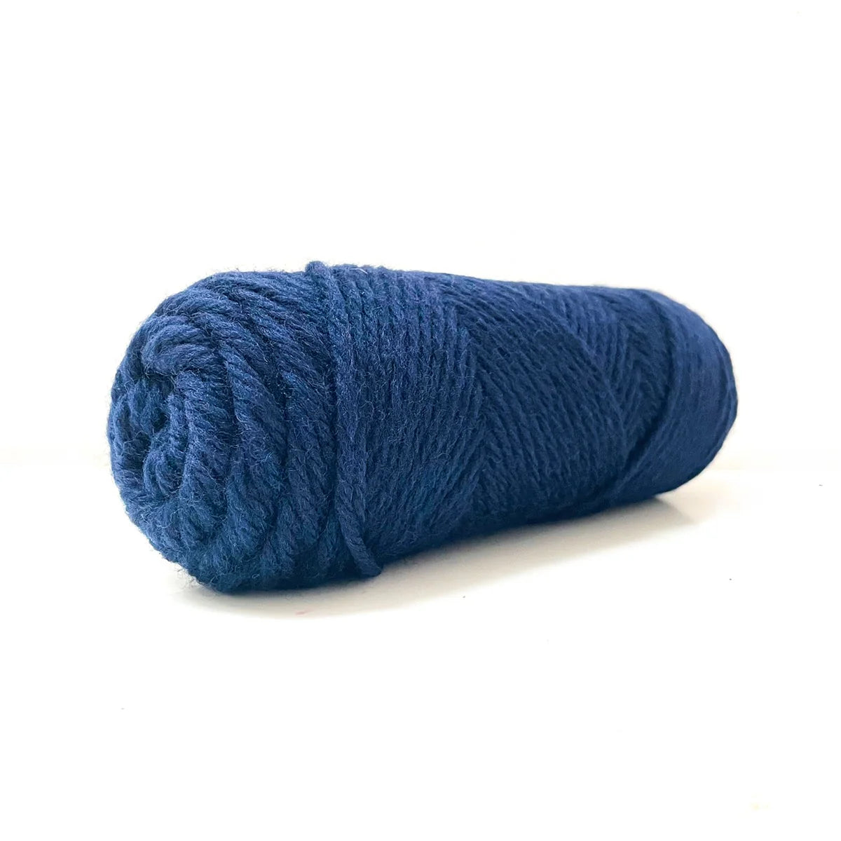 A skein of deep blue Kelbourne Woolens Germantown Bulky yarn.
