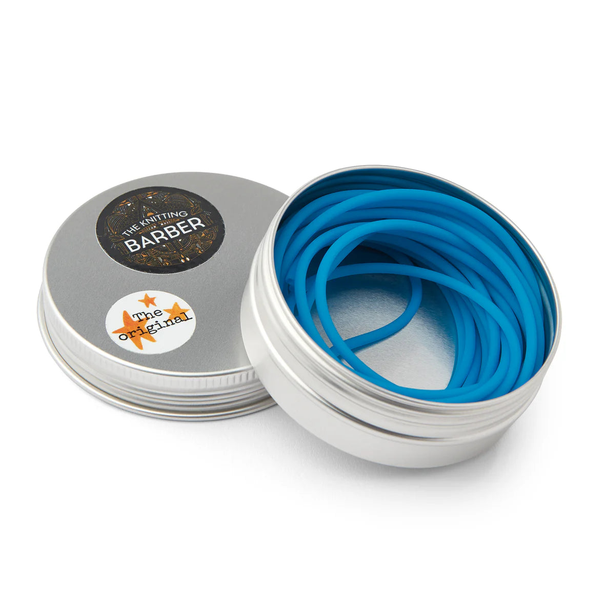 Round silver tin lying open beside its lid, showing light blue Knitting Barber Cords coiled inside.