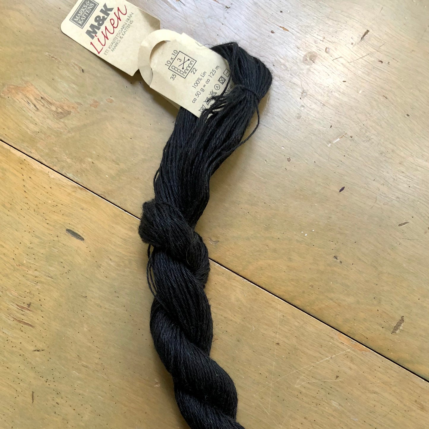 Black skein of M&K Linen yarn.
