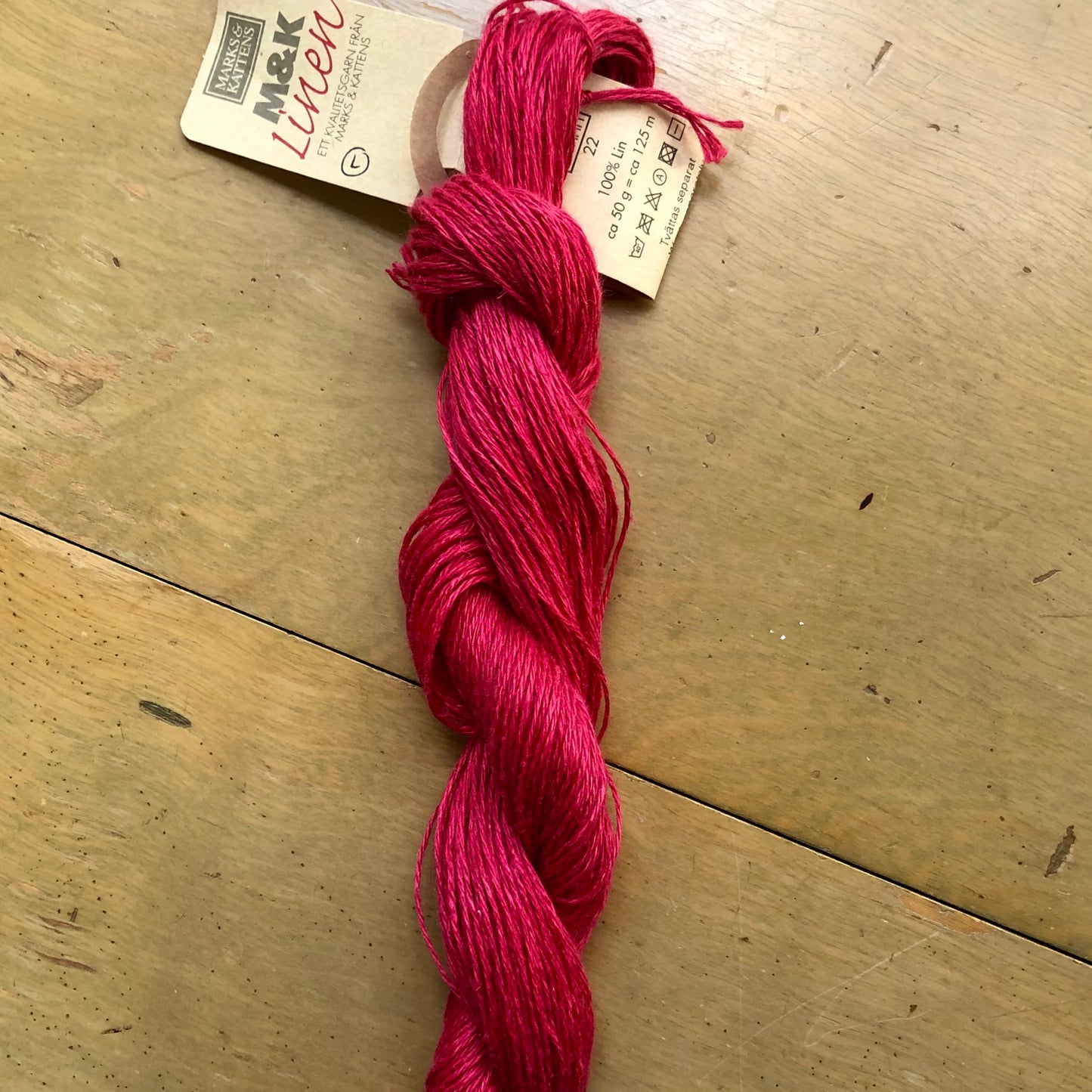 Red skein of M&K Linen yarn.