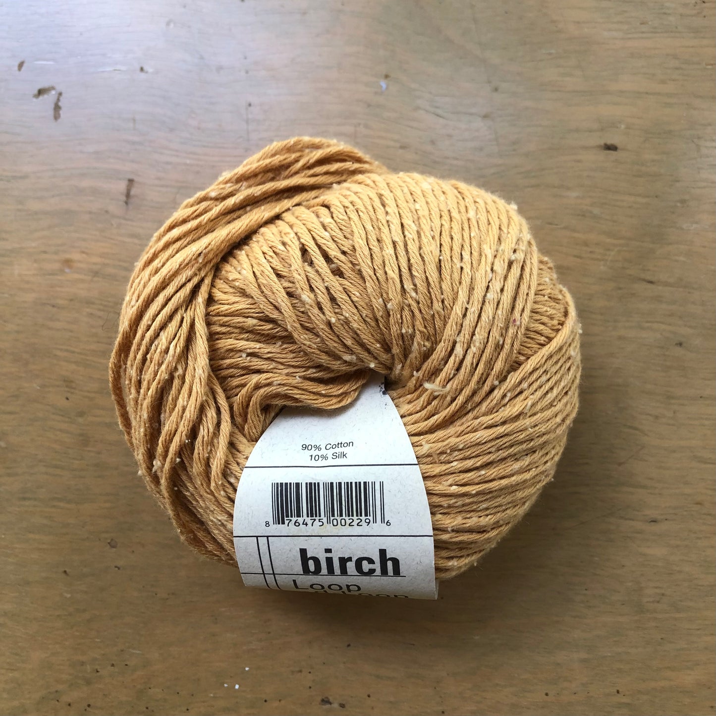 Golden yellow ball of Birch yarn, from Loop-d-Loop by Teva Durham.