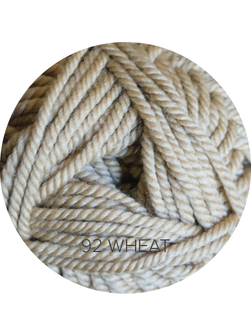 Close up on a beige ball of Ewe Ewe Baa Baa Bulky yarn.