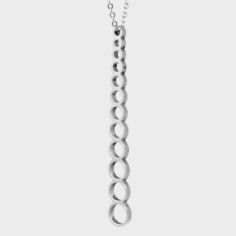 A long stainless steel pendant (attached to a neck chain) with vertical connecting holes to measure knitting needle sizes.