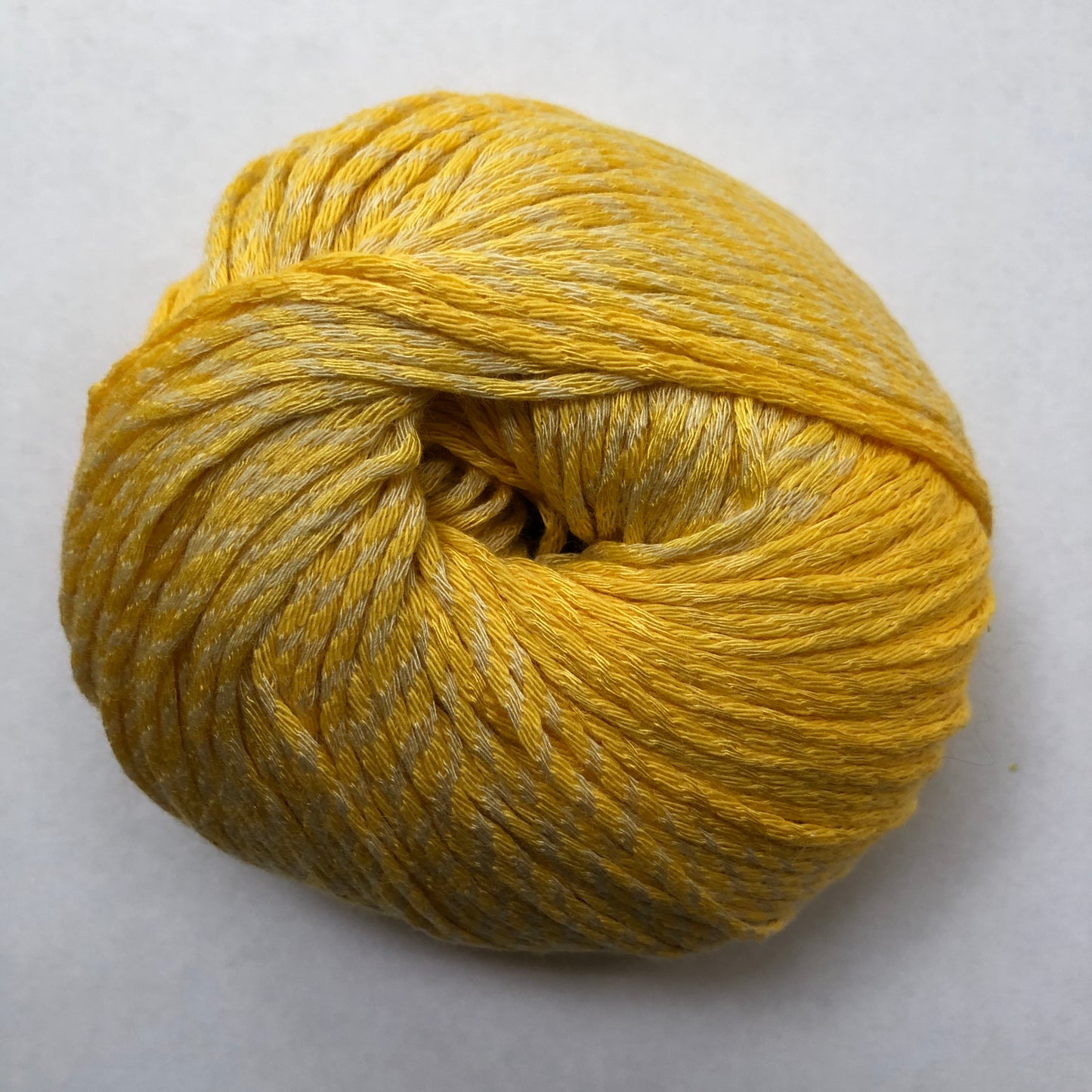 Ball of Lana Grossa Biosoja yarn in yellow color.