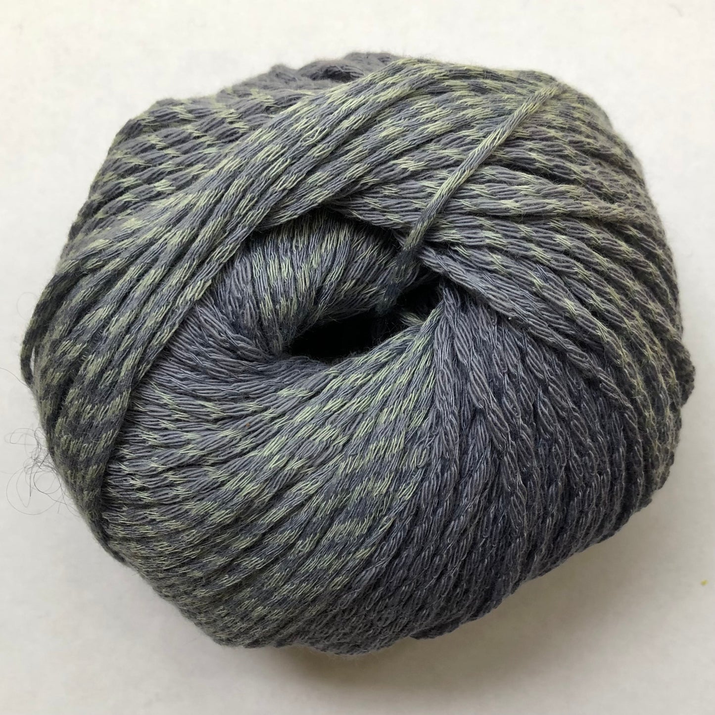 Ball of Lana Grossa Biosoja yarn in gray-blue with some light teal marled in.