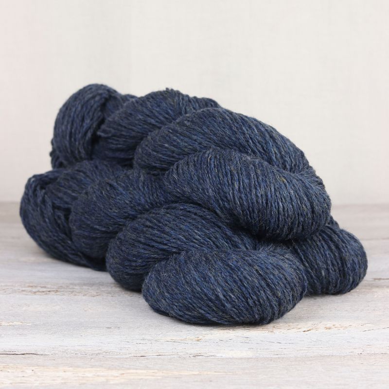 3 skeins of dark denim blue Fibre Co. Lore yarn.