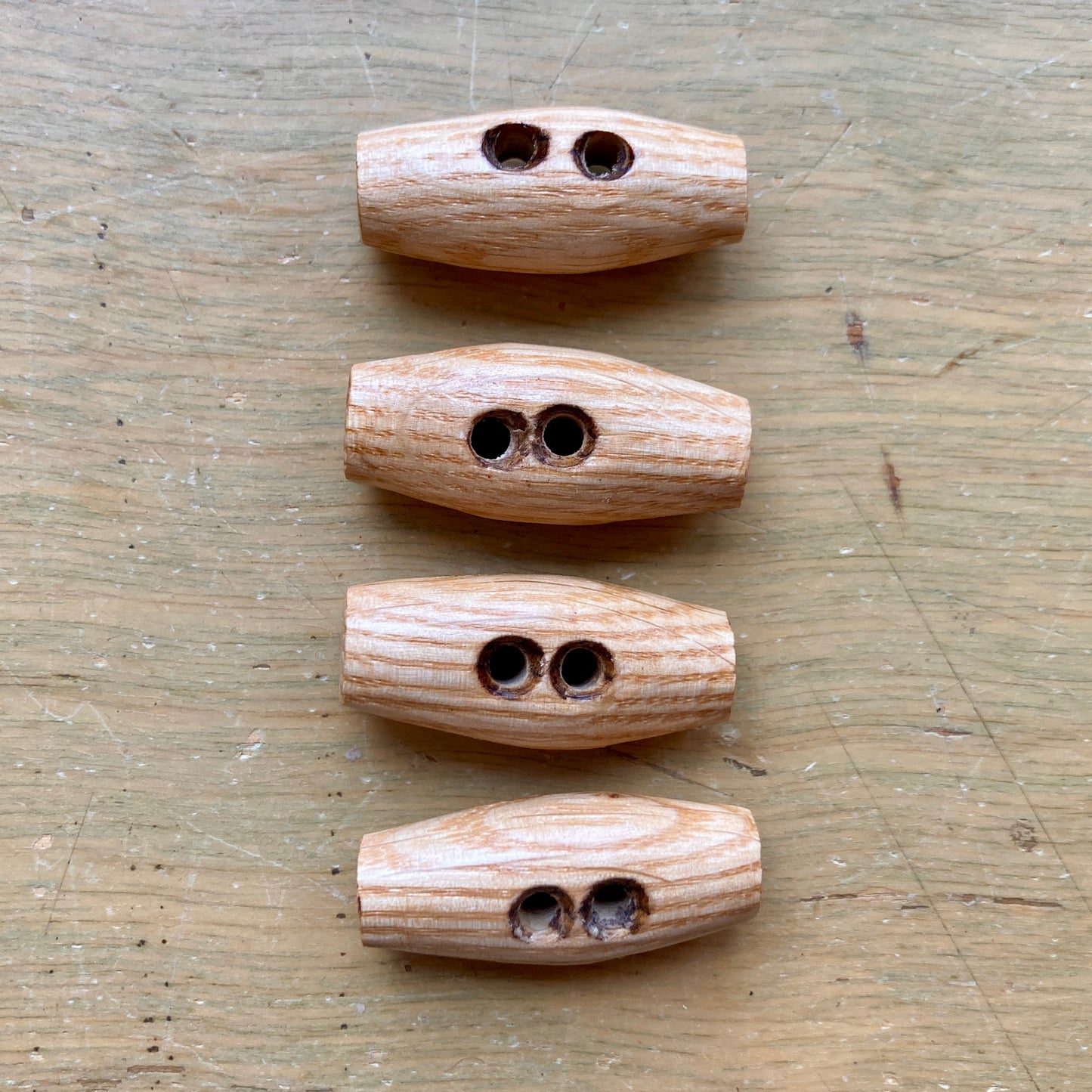 Nature’s Wonders toggle buttons in red oak