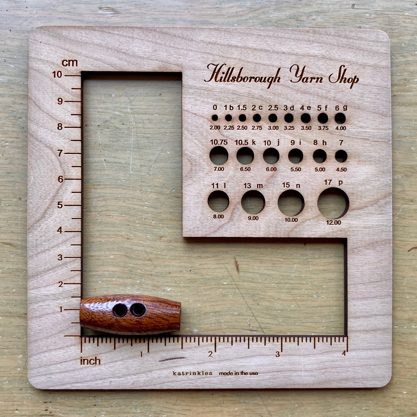 Nature’s Wonders toggle button in walnut, shown next to a HYS Gauge Tool for scale