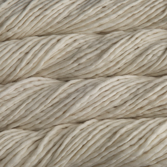 Close up on natural white skein of Malabrigo Rasta yarn.
