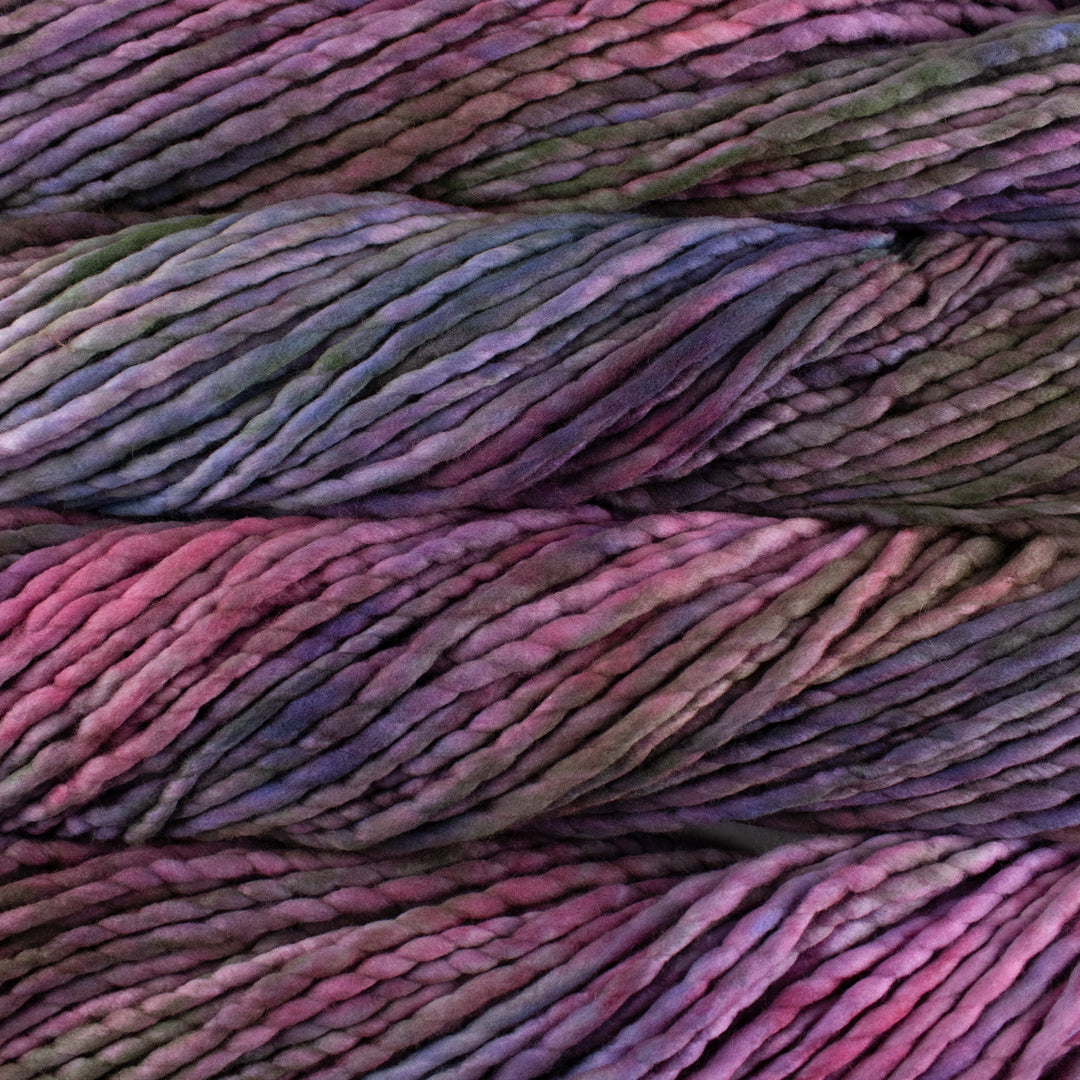 Close up on purple variegated skein of Malabrigo Rasta yarn in color Dreamscape.