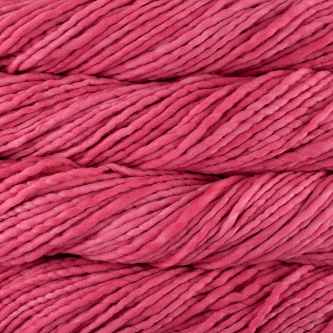 Close up on tropical pink skein of Malabrigo Rasta yarn in color Cactus Flower.