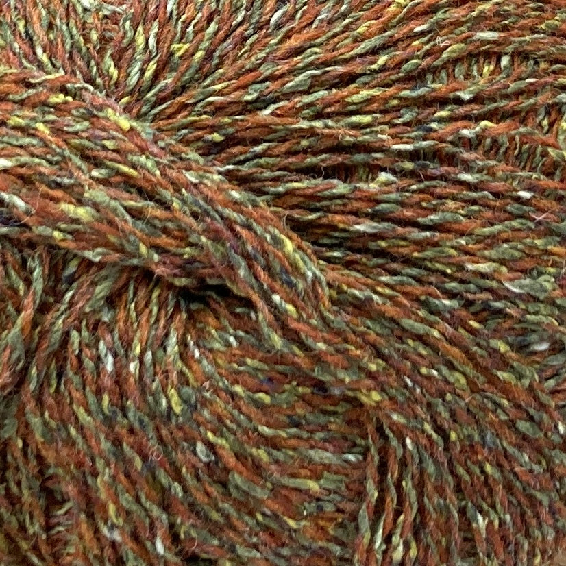 Close up on ball of Simply Shetland Silk & Lambswool yarn in tweedy rust and green marl, colorway Craignish