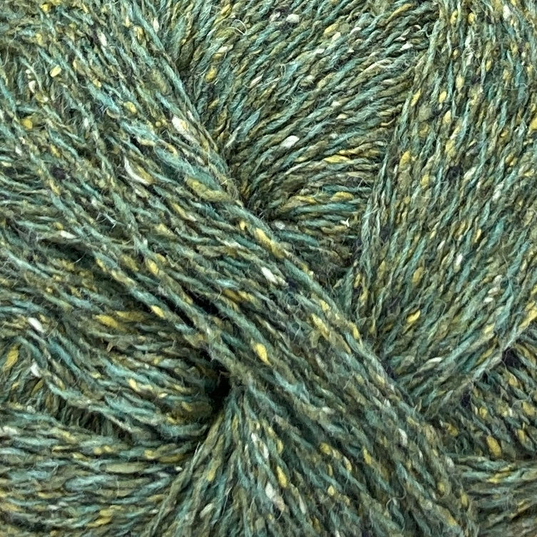 Close up on ball of Simply Shetland Silk & Lambswool yarn in tweedy bottle green, colorway Pitrivie