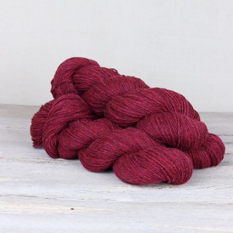 3 skeins of cherry red Fibre Co. Lore yarn.