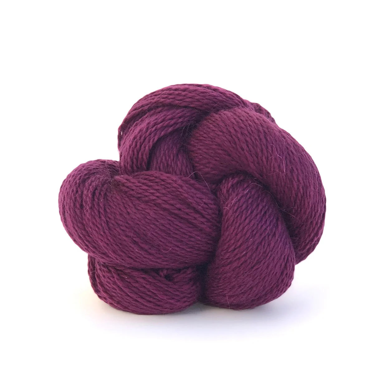 Skein of magenta Kelbourne Woolens Andorra yarn.