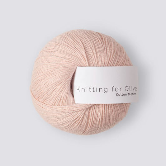 Ball of light pink yarn with 'Knitting for Olive' label on a light gray background