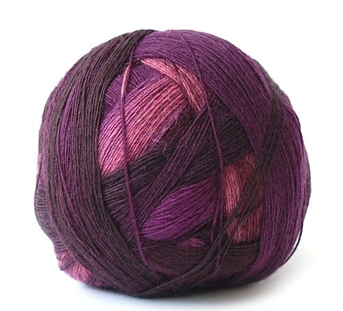 One ball of Schoppel-Wolle lace merino yarn in ombré purple hues.