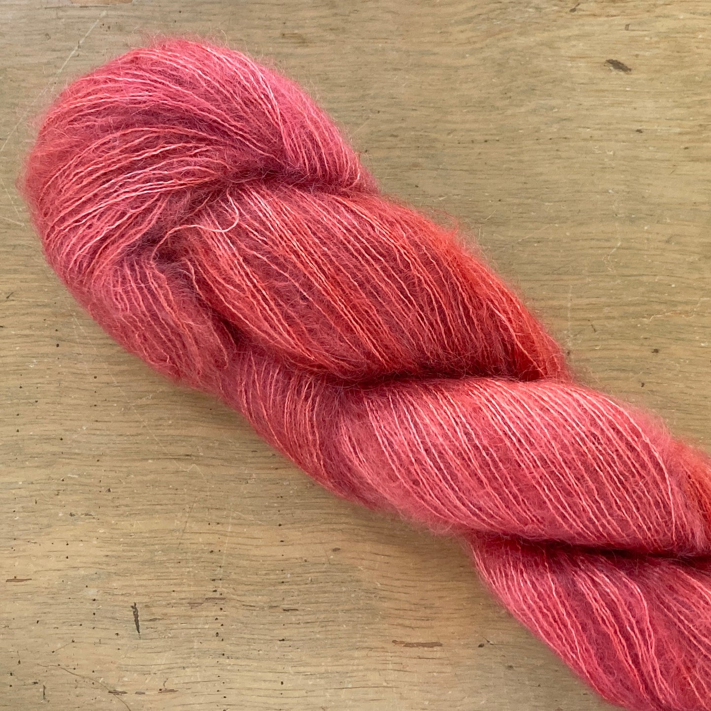 Coral skein of Fleece Artist / Hand Maiden Superkid Silk yarn.