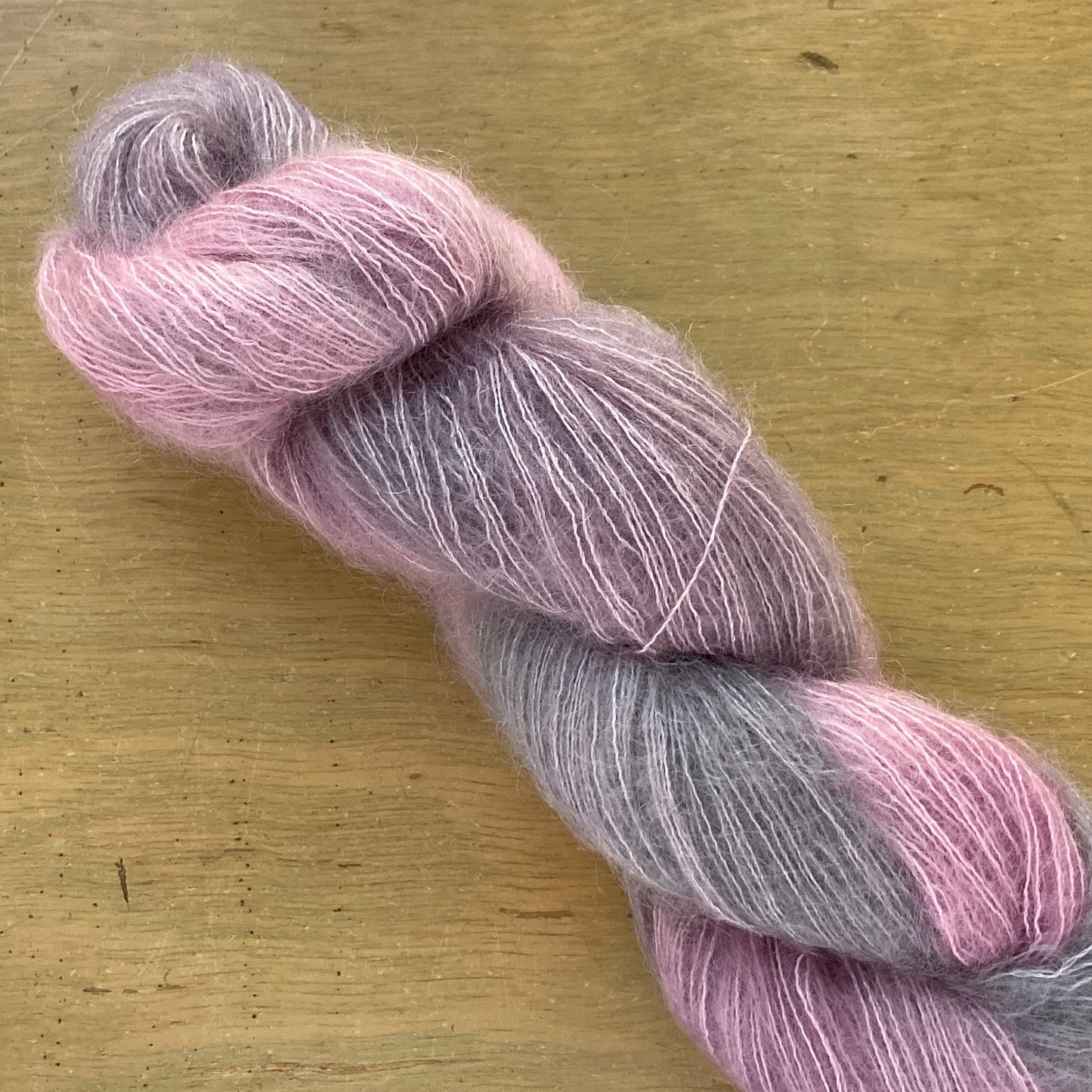 Lavender gray and pink skein of Fleece Artist / Hand Maiden Superkid Silk yarn, colorway Moonstone