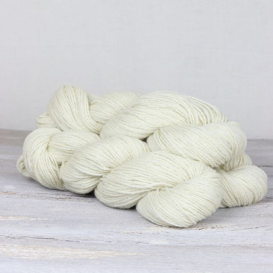 3 skeins of white Fibre Co. Lore yarn.