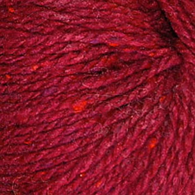 Close up on a red tweed ball of Queensland Kathmandu Aran yarn.
