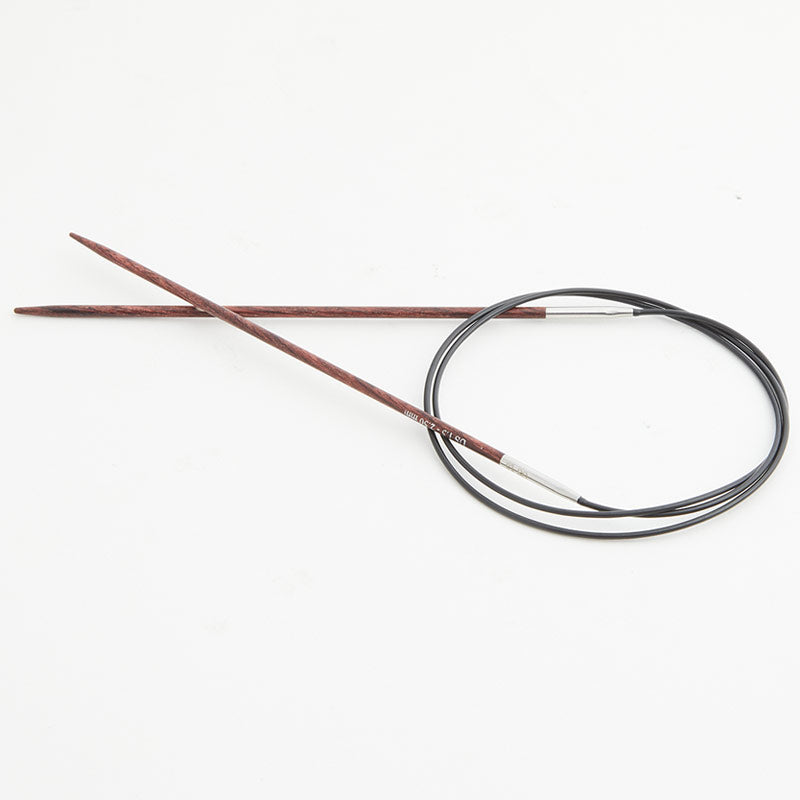 Brown circular knitting needles, connected by a black cord.