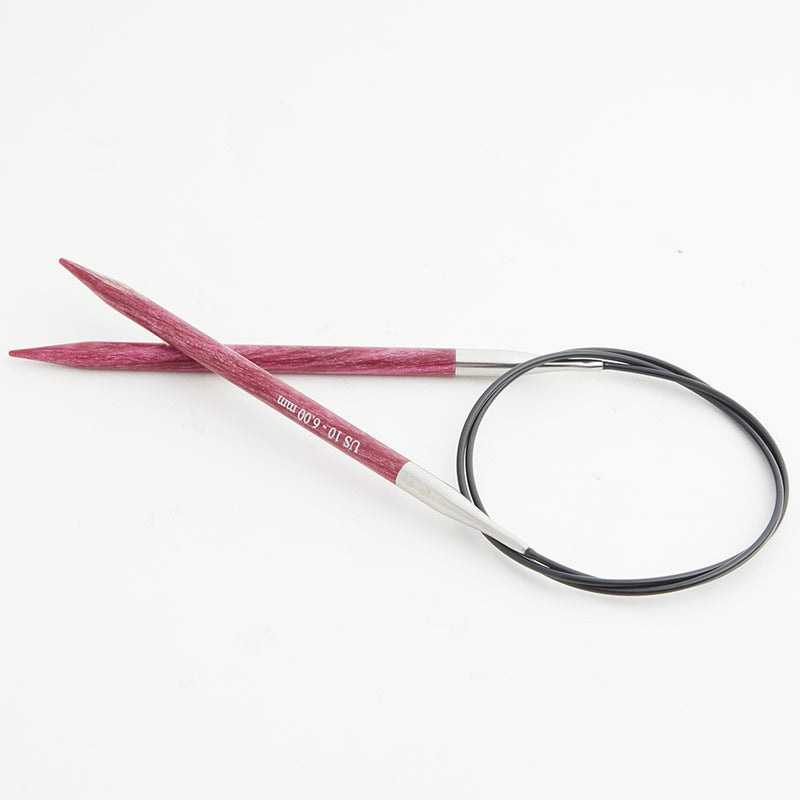 Pink circular knitting needles, connected by a black cord.