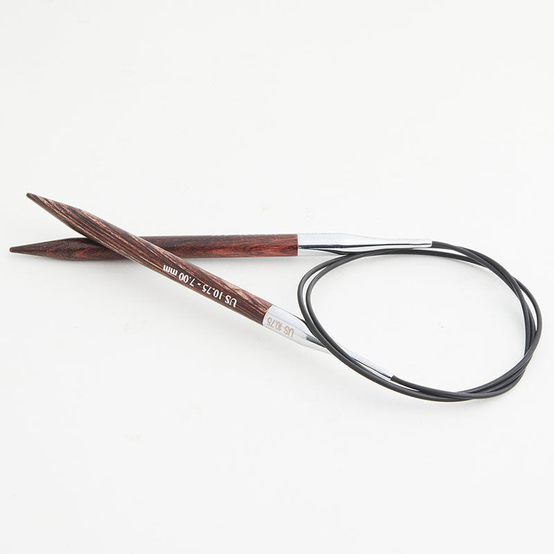 Dark brown circular knitting needles, connected by a black cord.