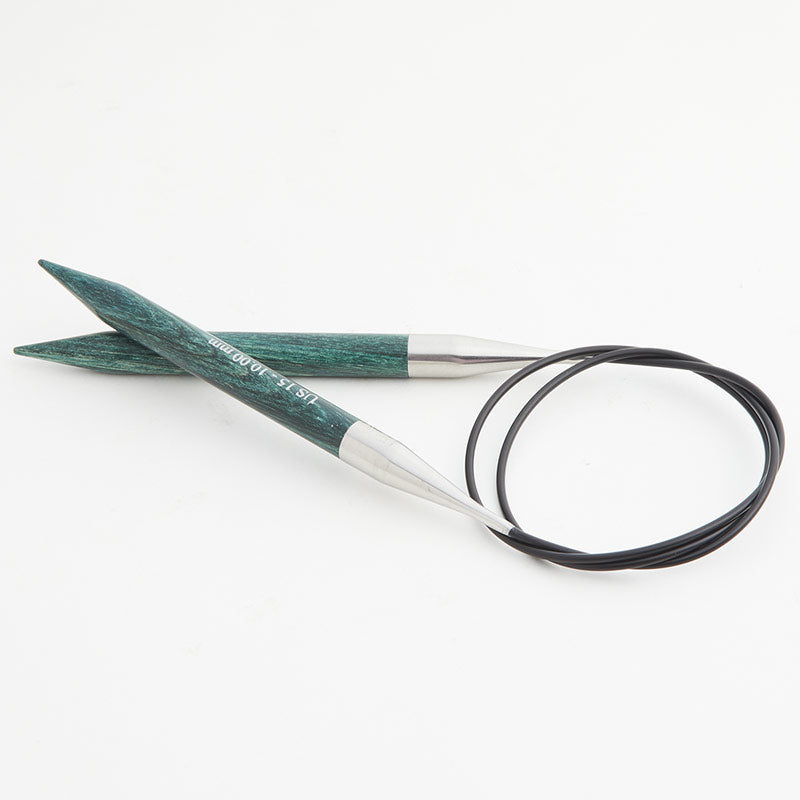 Teal circular knitting needles, connected by a black cord.