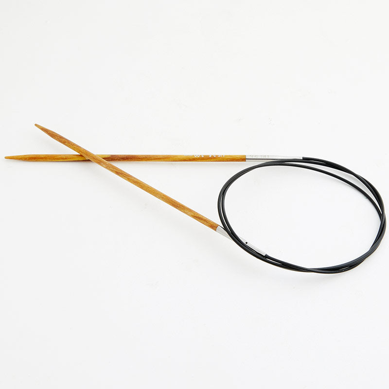 Golden yellow circular knitting needles, connected by a black cord.