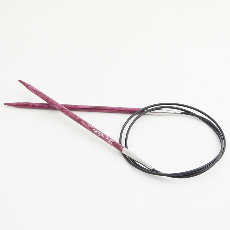 Pink circular knitting needles, connected by a black cord.