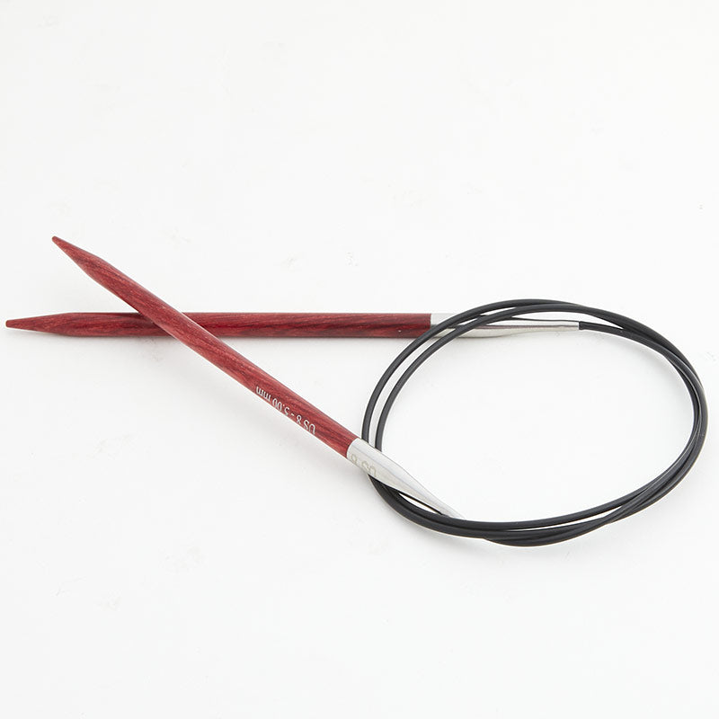 Red circular knitting needles, connected by a black cord.