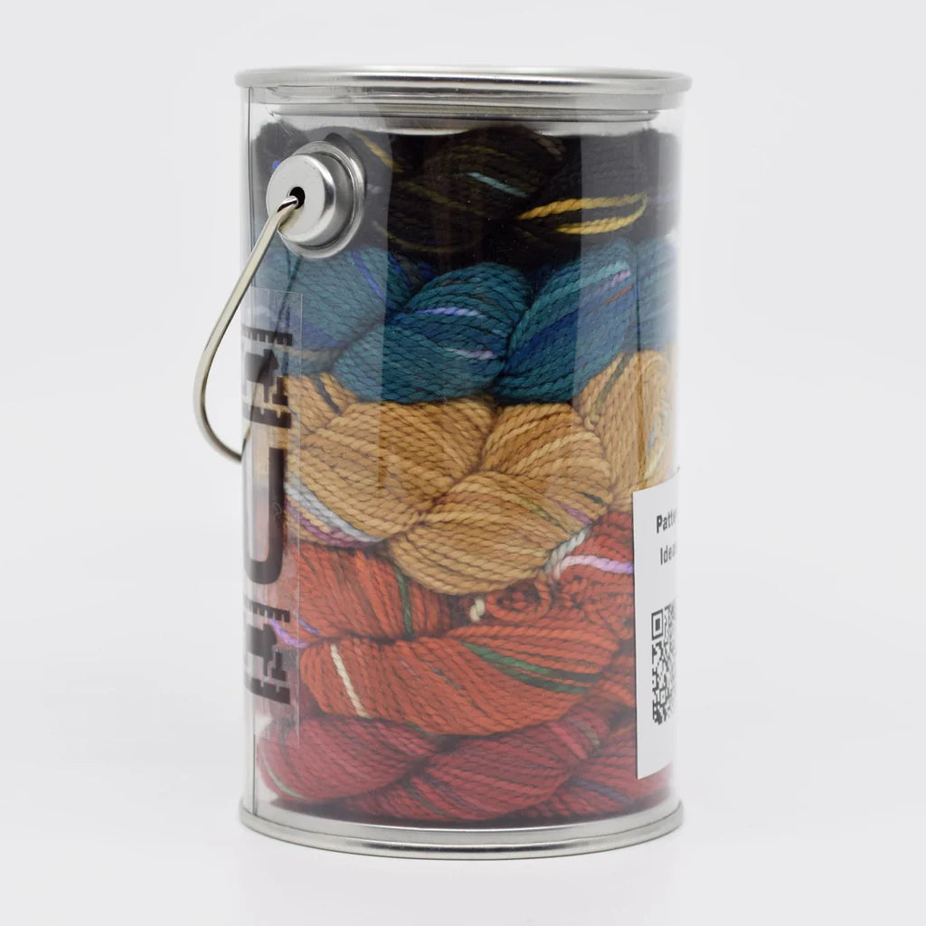 Clear plastic container filled with colorful hand dyed yarn.