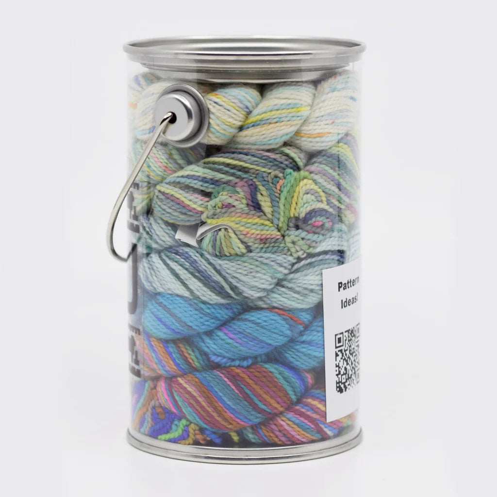 Clear plastic container filled with colorful hand dyed yarn.