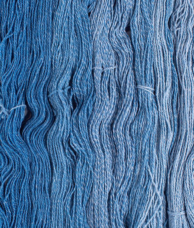 Skeins of bright blue Brooklyn Tweed Dapple yarn. 