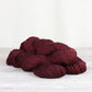 3 skeins of burgundy Fibre Co. Acadia yarn. 