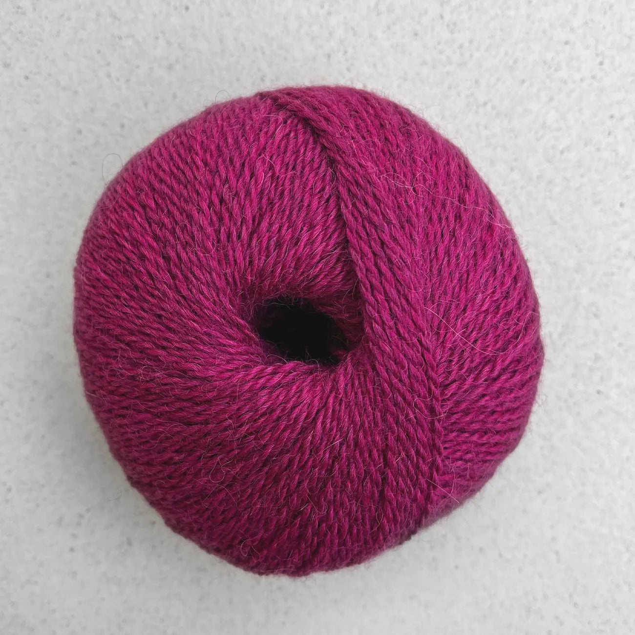 Ball of magenta Pascuali Balayage yarn. 