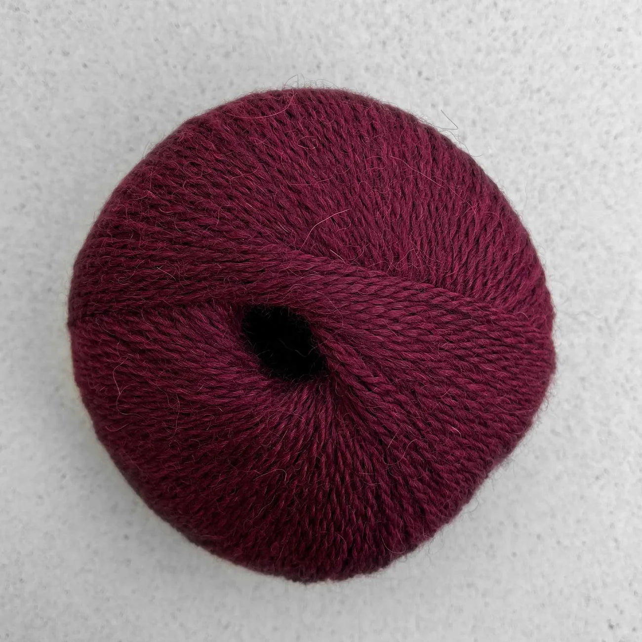 Ball of dark red Pascuali Balayage yarn. 