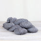 3 skeins of purple gray Fibre Co. Acadia yarn. 