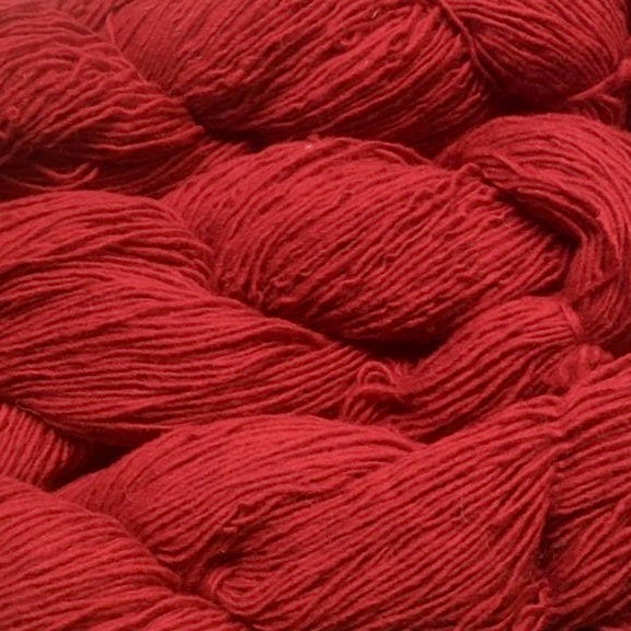 Close up on a bright red skein of Briggs & Little Sport yarn. 